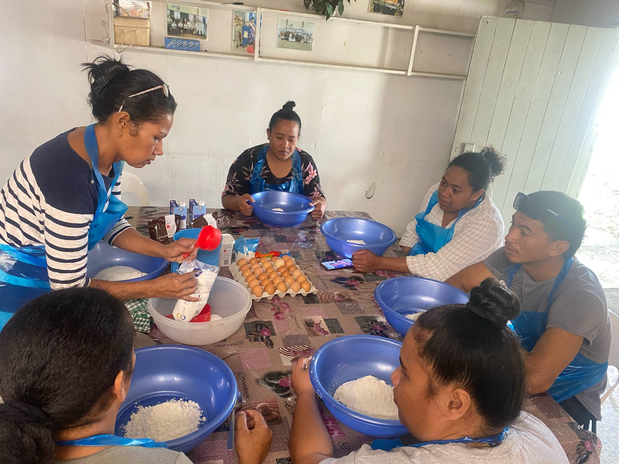 members sitting in a circle learning to cook
