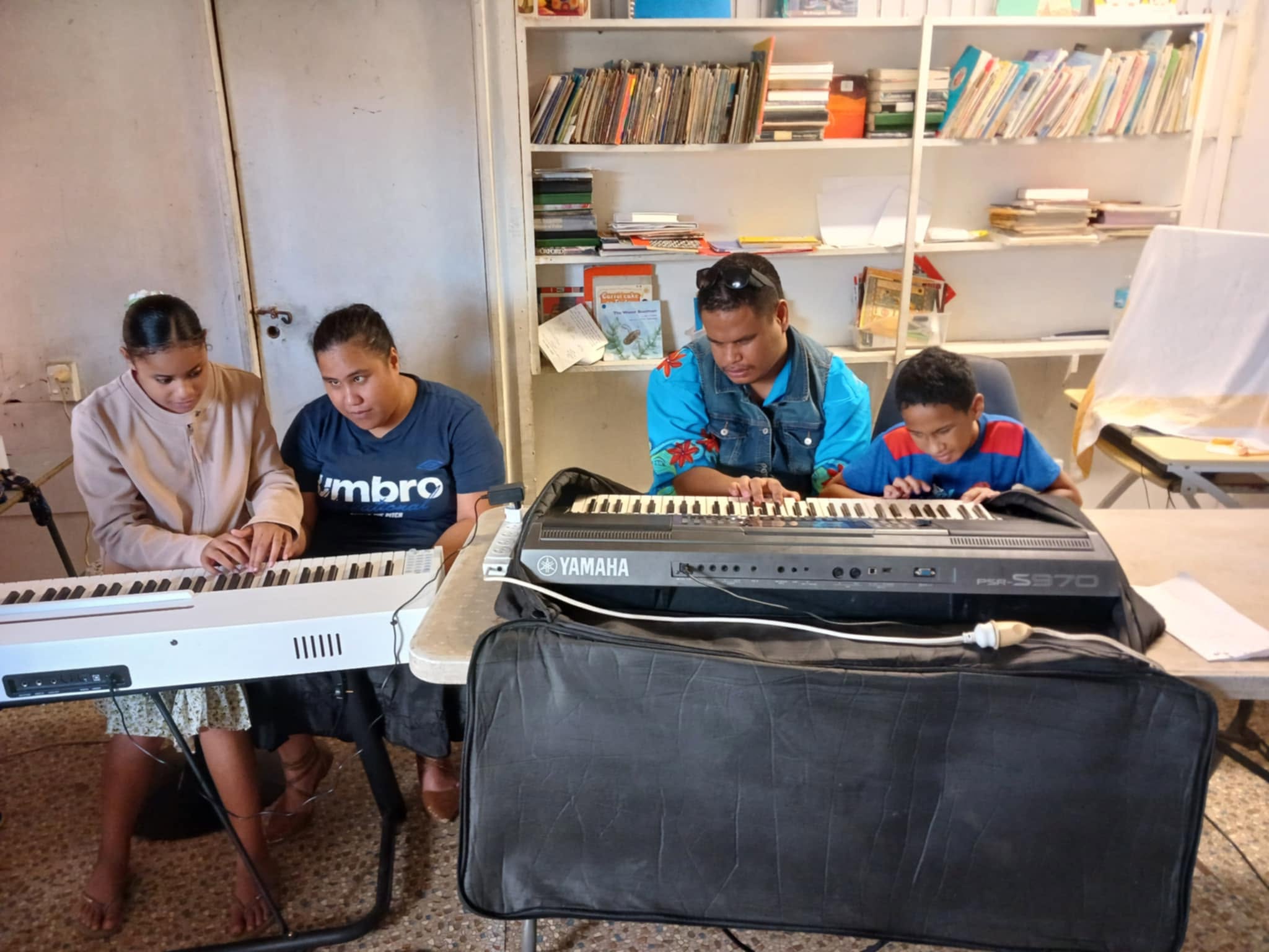 members learning to play keyboard